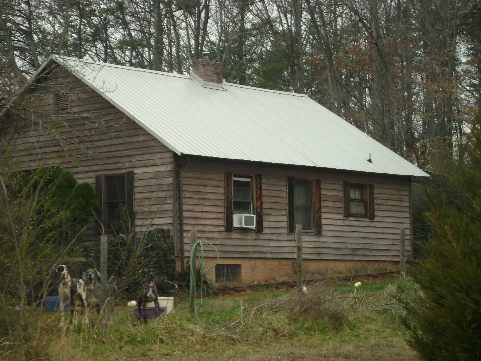 White metal roof on an old wood sided farmhouse, from a Metal Roof Installation job in Dracut